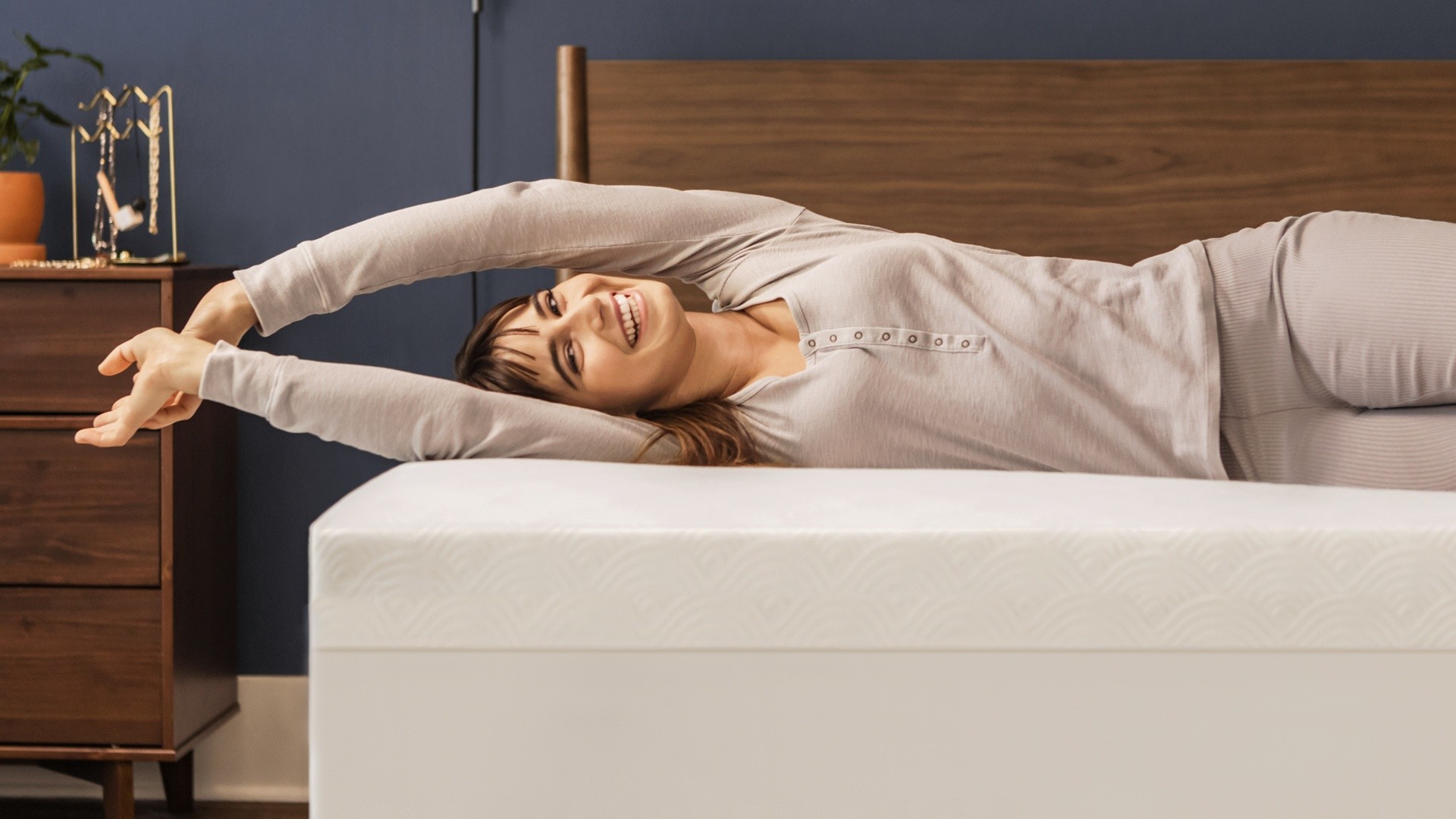 woman laying on 3 inch cloud topper on undressed mattress