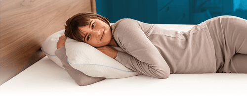woman resting her head on tempur cloud adjustable pillow with blue gradient